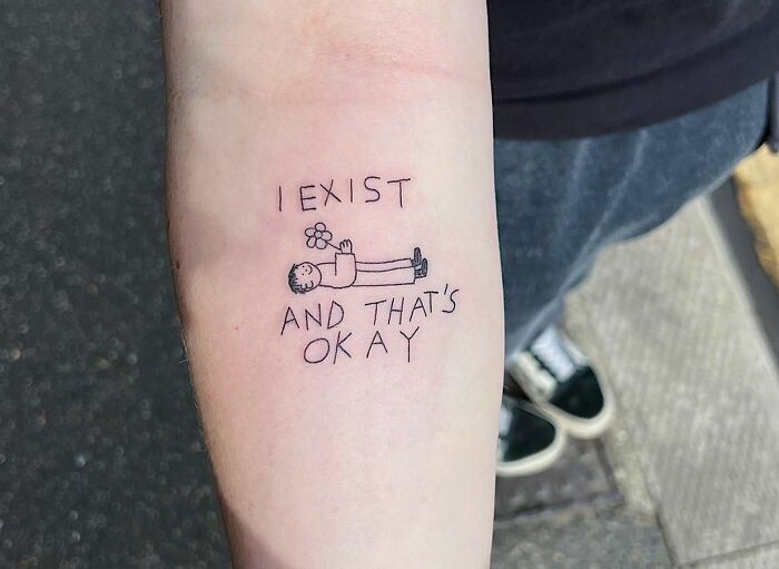 "I Exist And That's Okay" phrase with man holding a flower 