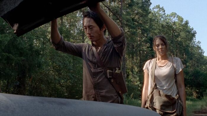 Glenn Rhee holding the car hood