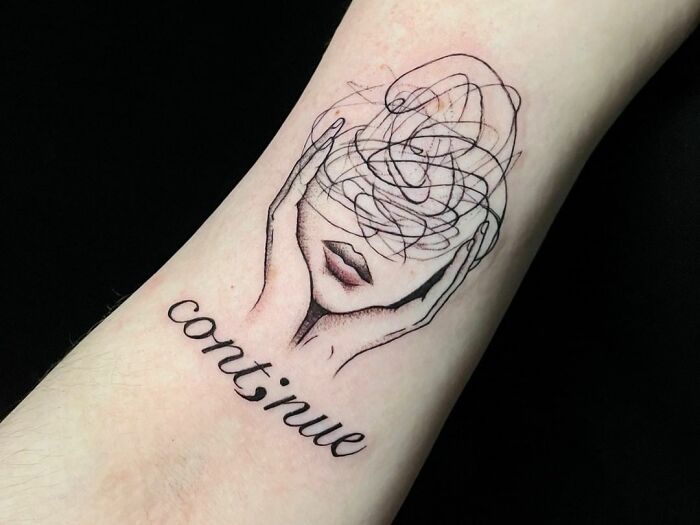 "Continue" word with confused face tattoo 