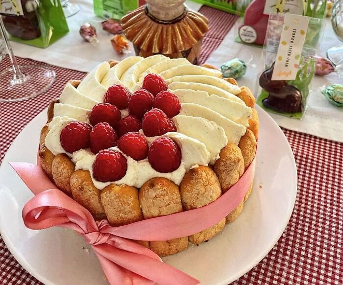 Charlotte Russe dessert with cream and raspberries on top