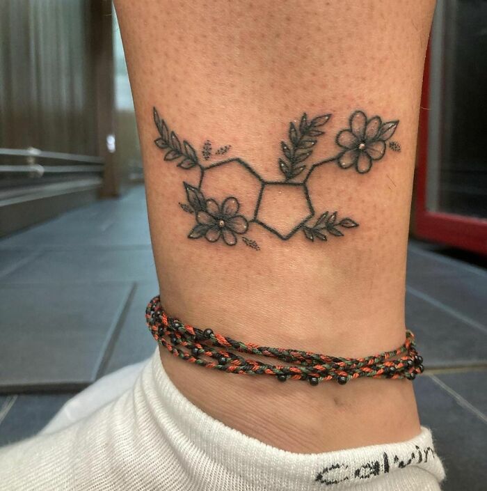 Serotonin molecule with flowers ankle tattoo