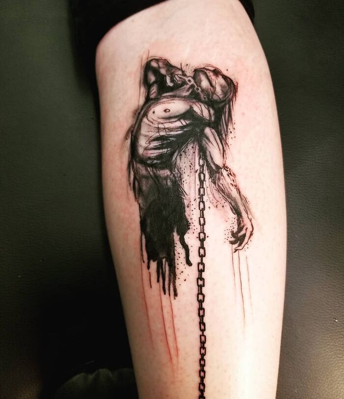 Mans' posture with chains tattoo 