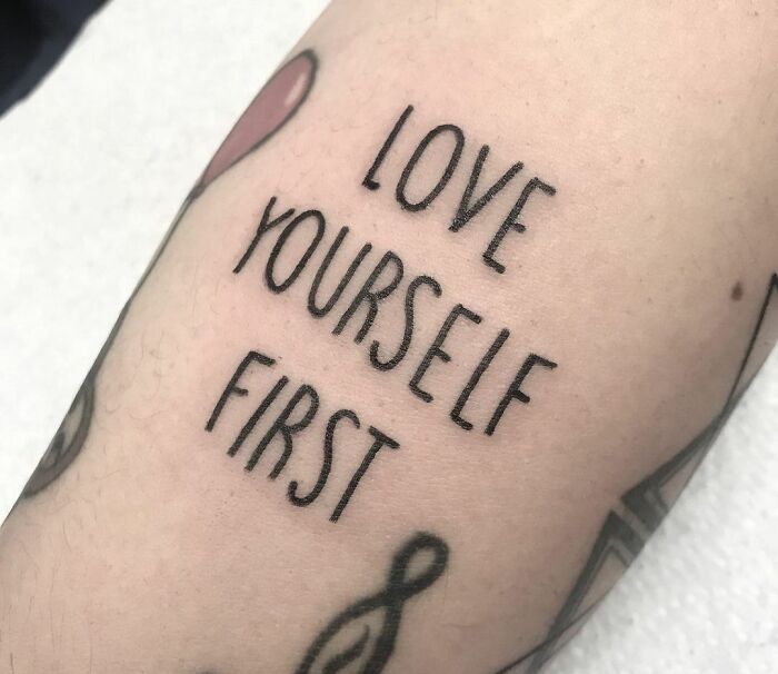 "Love yourself first" phrase tattoo