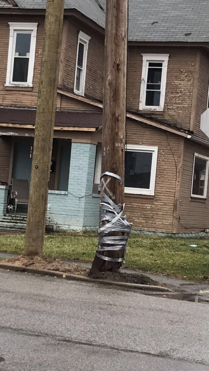 This Electrical Pole Is Being Held Together By Duct Tape