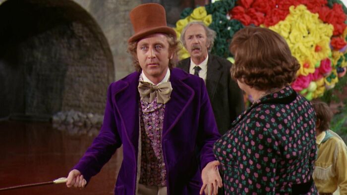 Willy Wonka is talking with Mrs. Gloop 