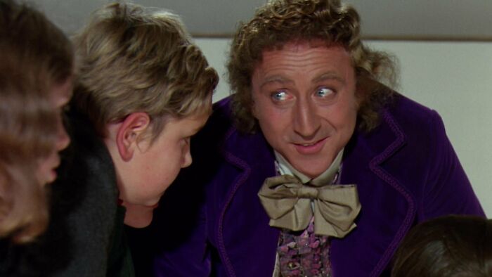 Willy Wonka is talking to Augustus 