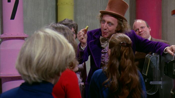 Willy Wonka showing gum to the kids 