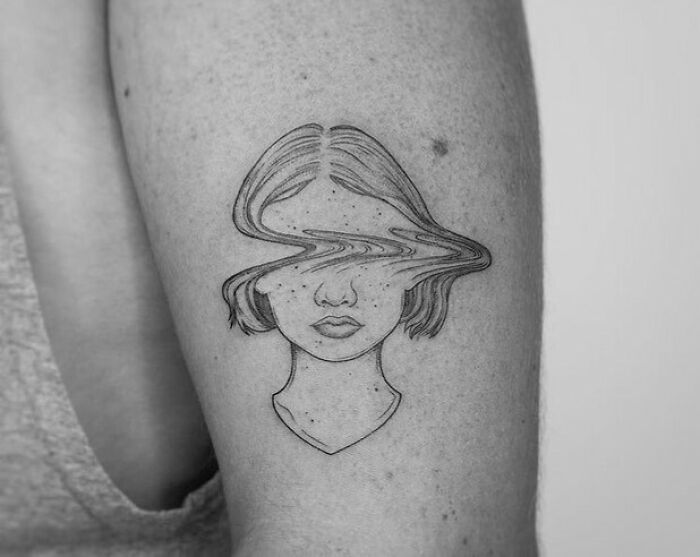 Female with blurry face tattoo 