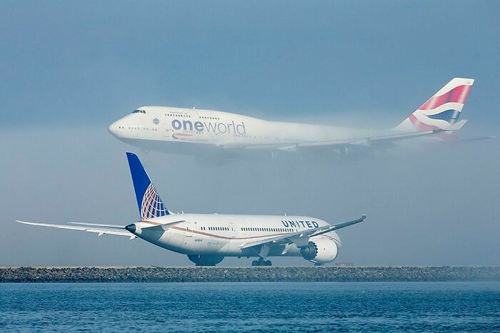 A United Airlines Boeing Dreamliner Holds Position At San Francisco As A British Airways Boeing Beautifully Descends Through The Fog To Land