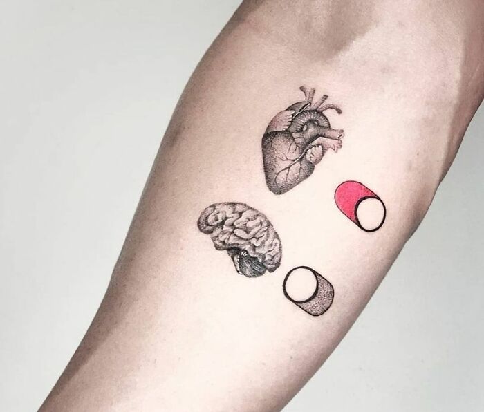 Heart on the "On mode" while brain is on the "off" arm tattoo