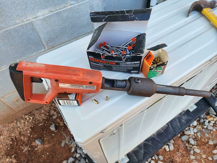 A Literal Nail Gun Used For Shooting A Nail Into Concrete Using 22 Caliber Blanks