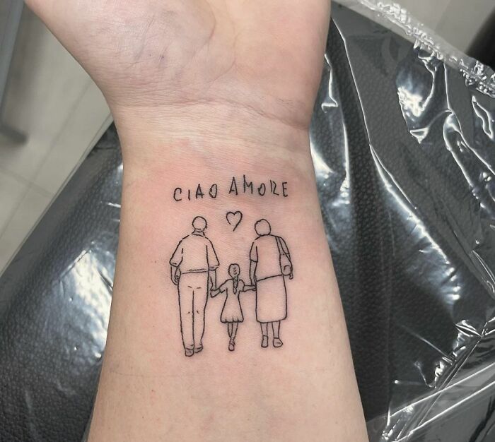 Grandparents walking with granddaughter and the 'ciao amore' script wrist tattoo