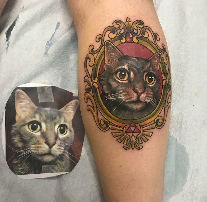 Realistic picture portrait of a cat in a golden vintage frame forearm tattoo