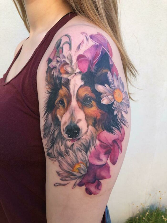 Colorful realistic dog face and flowers arm tattoo
