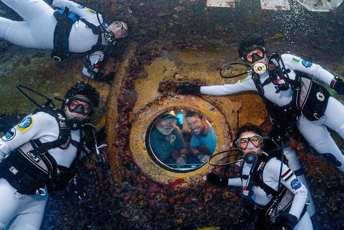 Divers Pose Outside The Aquarius Reef Base, An Underwater Training Center Run By Nasa Off The Coast Of Florida