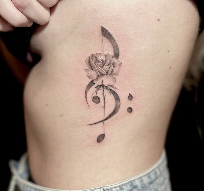 Musical notes and rose tattoo