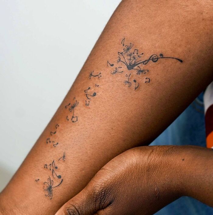 Black flower and music notes tattoo