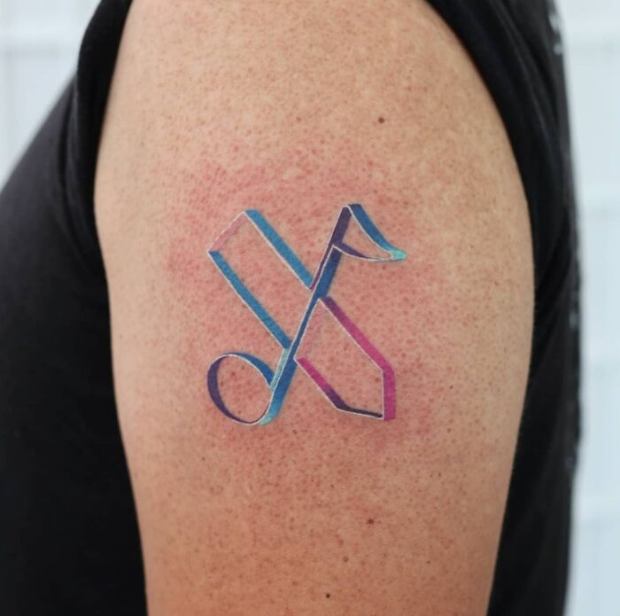 Colorful Music logo tattoo on arm