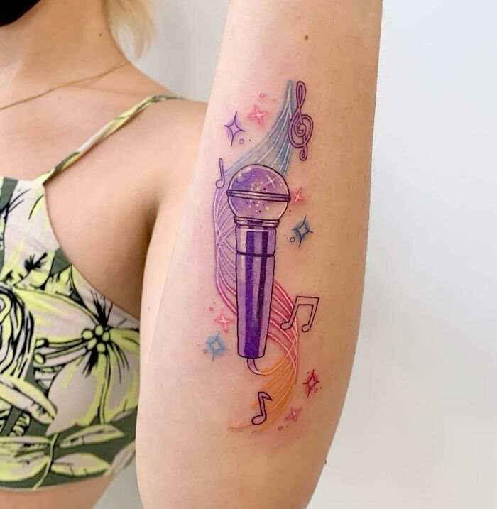 Purple mic tattoo on arm