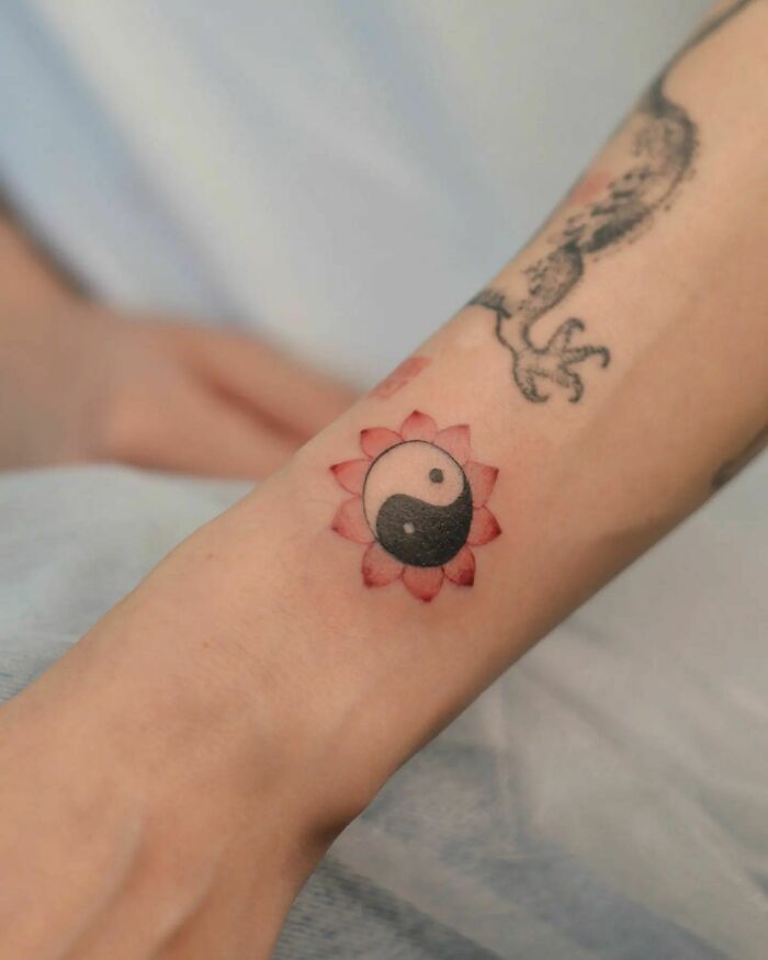 Yin yang symbol with flower tattoo