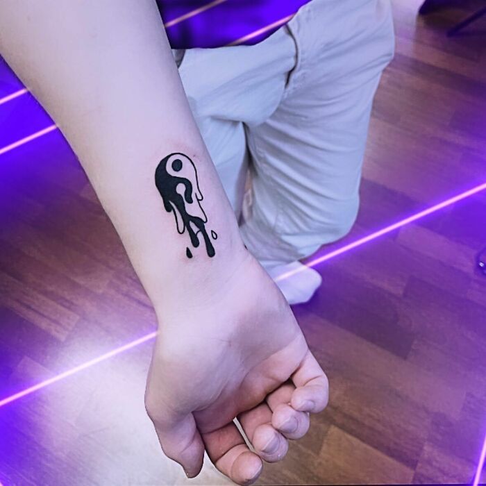 Melting yin yang symbol tattoo