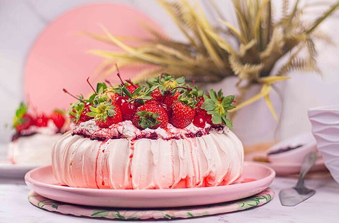 Pavlova with strawberries on top
