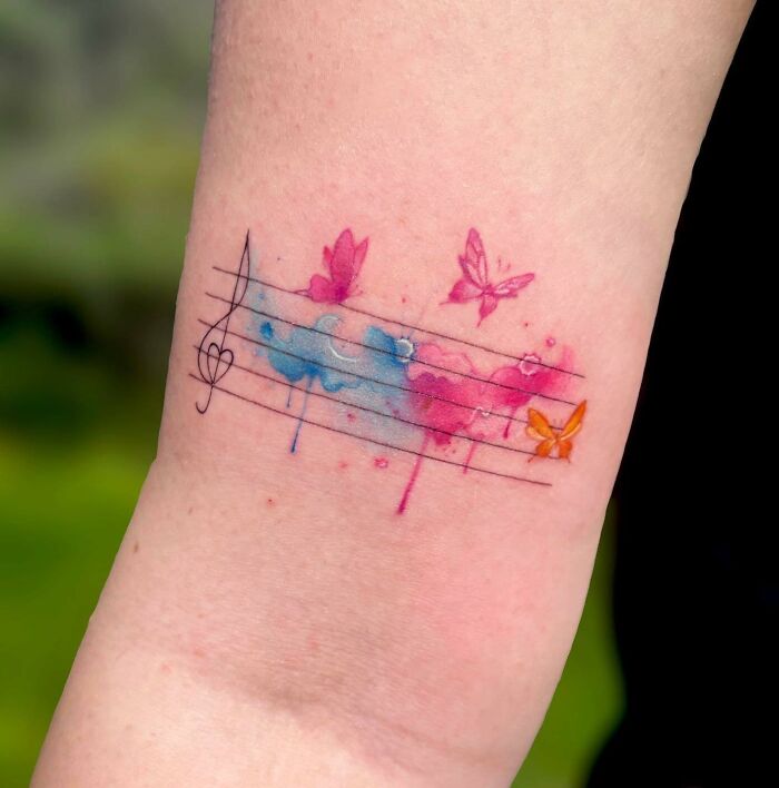 Watercolor music tattoo with butterflies