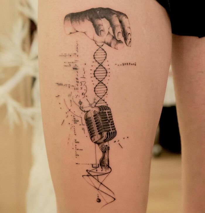 Realistic tattoo with hand, spiral and vintage microphone