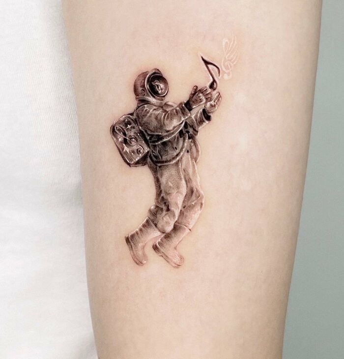 Astronaut with musical notes tattoo