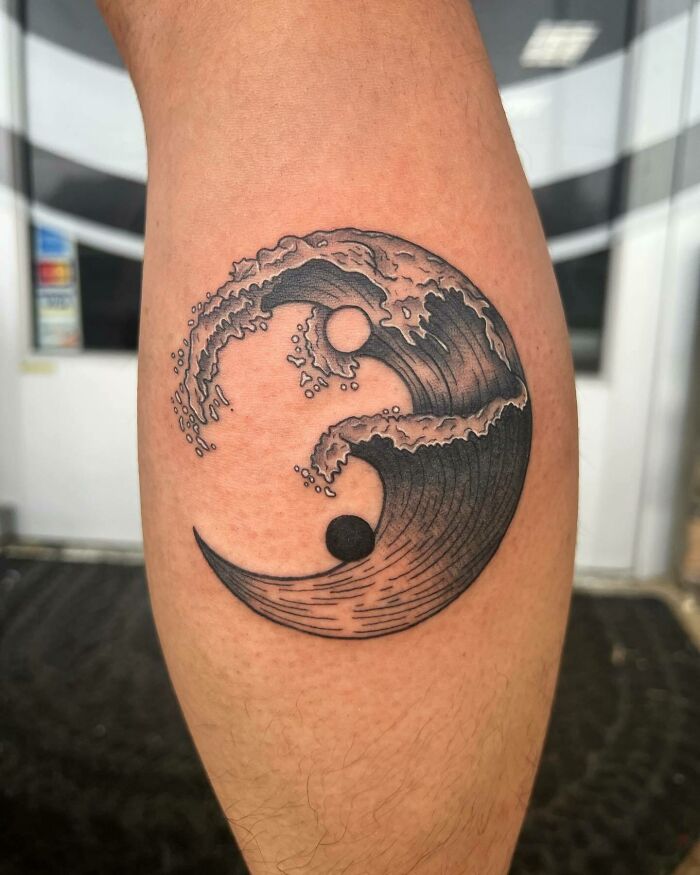 Wave forming yin yang symbol tattoo 