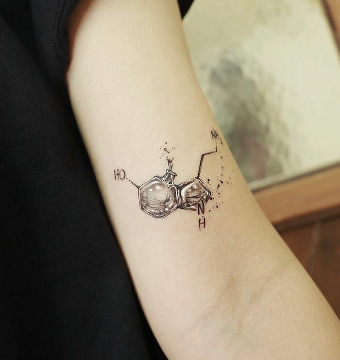 Serotonin chemistry tattoo on arm