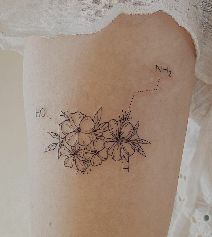 Black linear floral serotonin molecule tattoo on arm