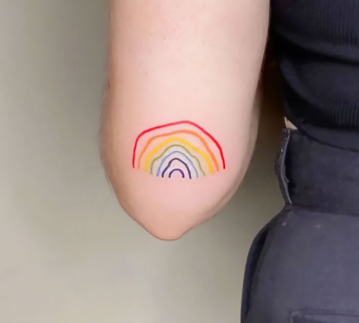 Colorful rainbow tattoo on the elbow
