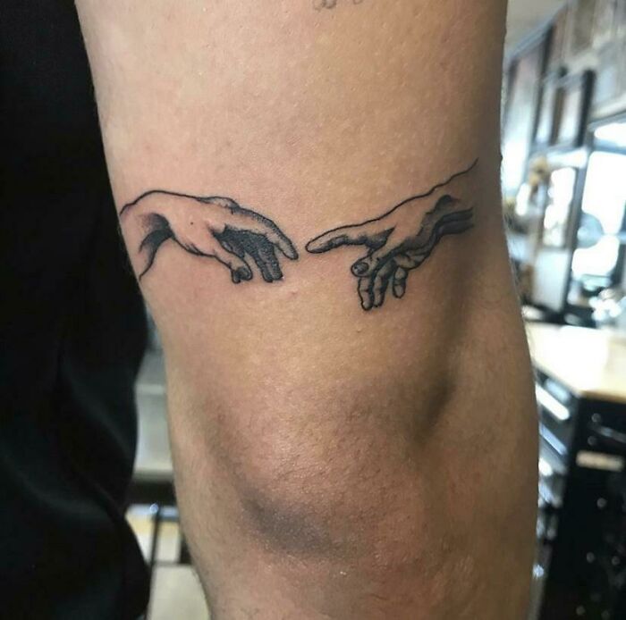 Sistine Chapel tattoo on the elbow