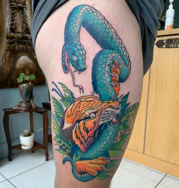 snake thigh tattoo