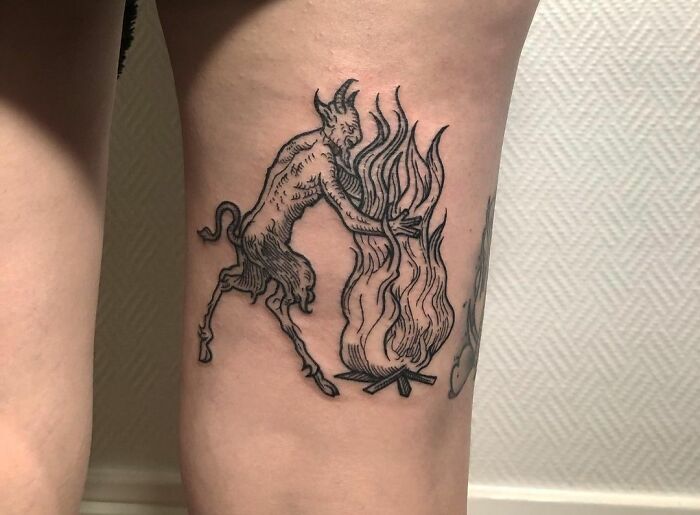 Devil Playing with fire hamstring tattoo