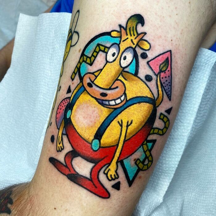 90's Heffer Wolfe yellow character wearing red pants tattoo