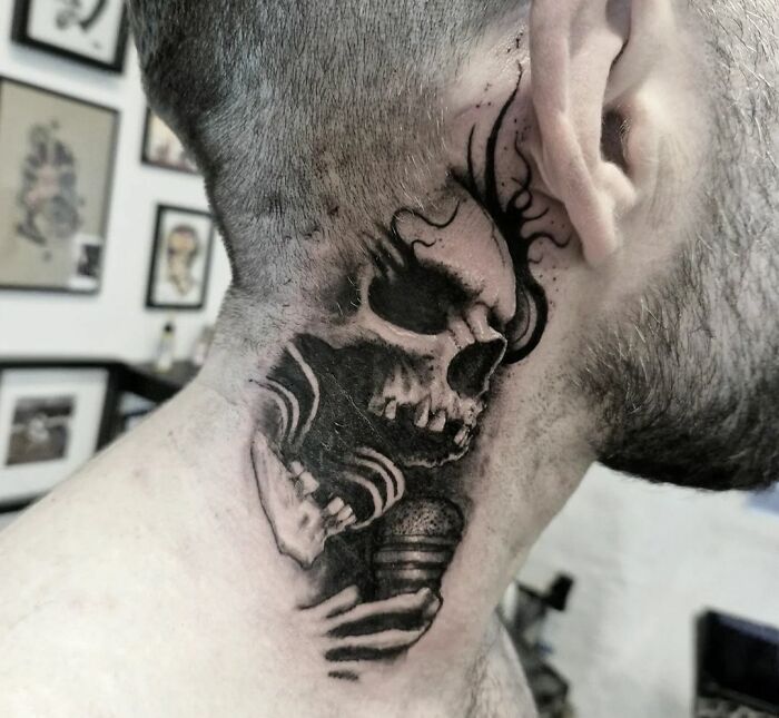 Neck tattoo featuring a detailed Gothic skull design.