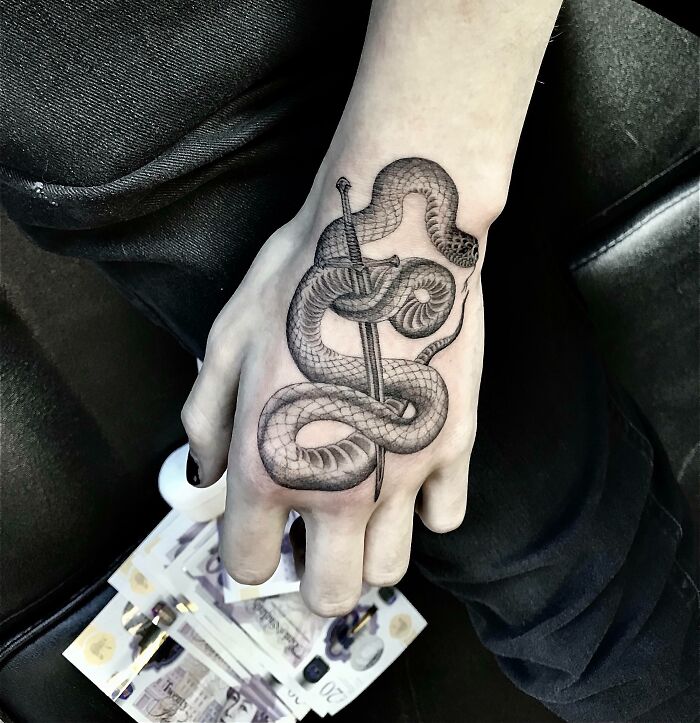 snake hand tattoo