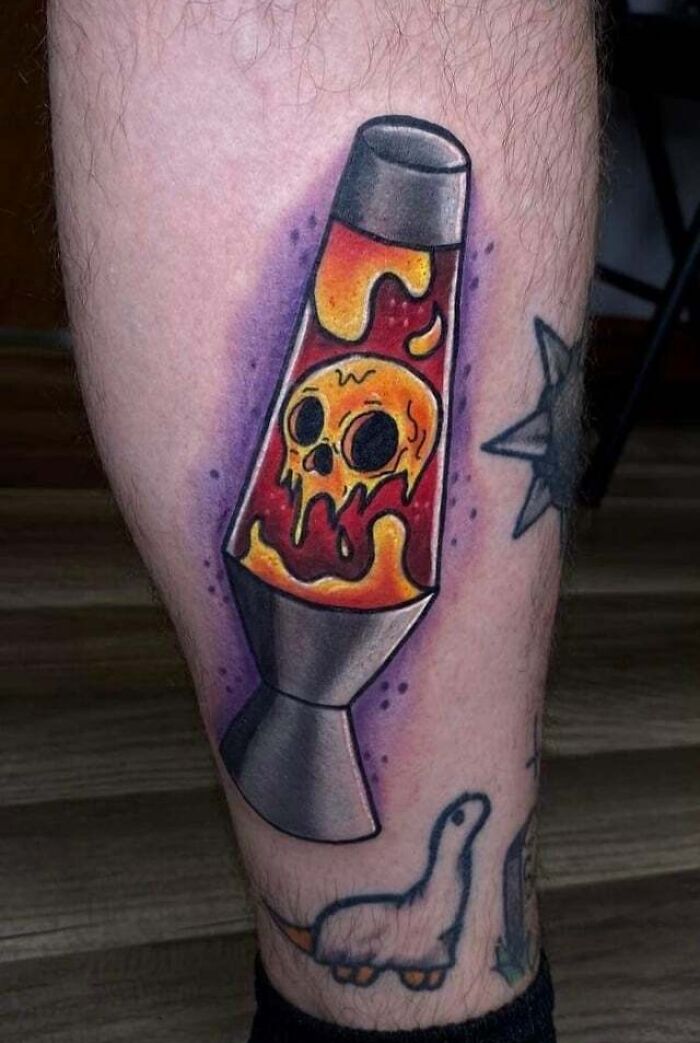 orange Firey Lava Lamp with skull inside leg tattoo