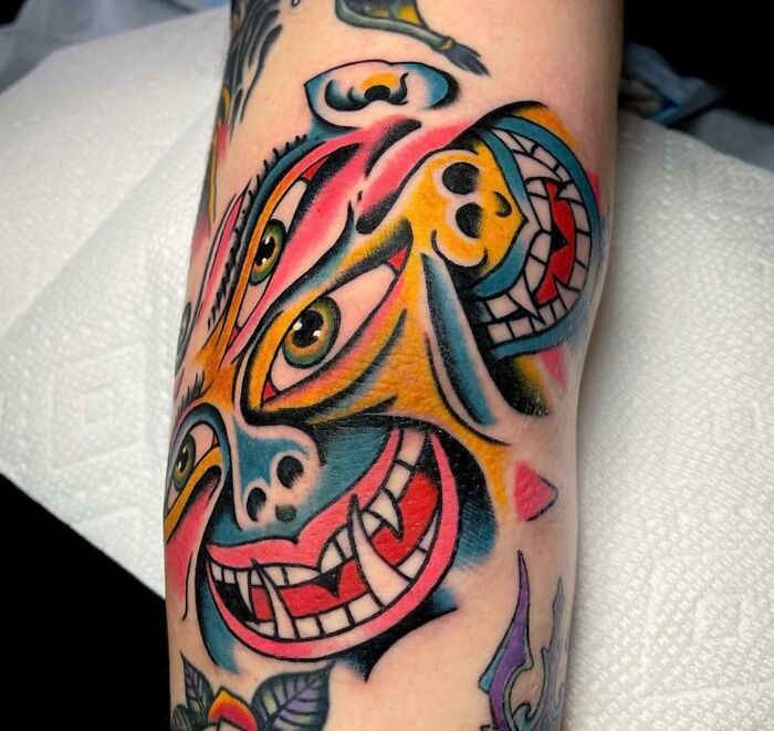 Colorful funny faces elbow tattoo