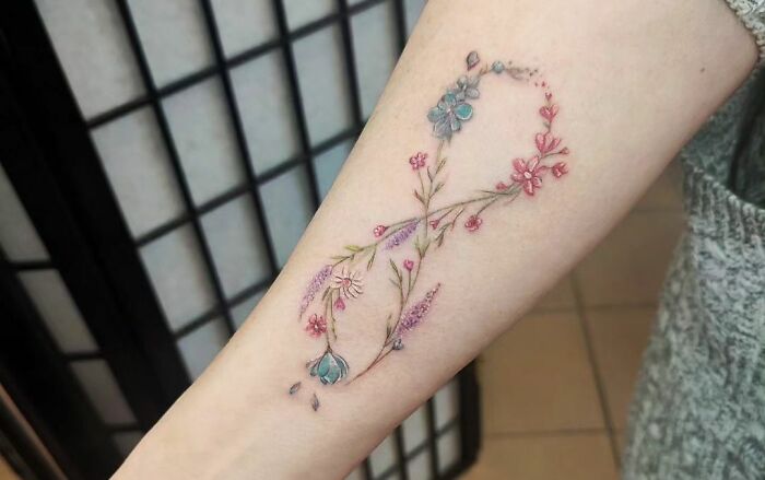 infinity colorful flowers tattoo on hand