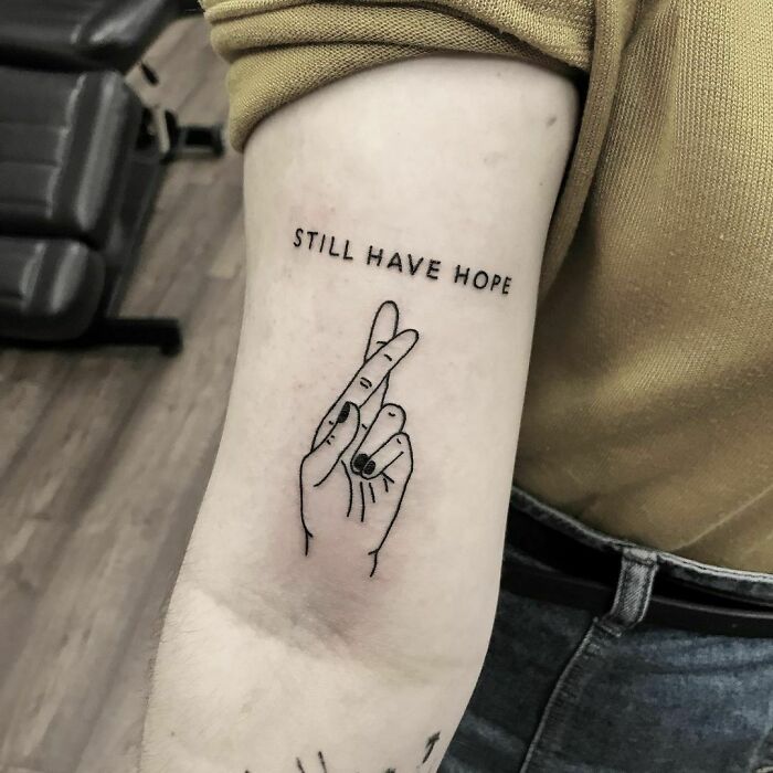 "Still have hope" and fingers crossed tattoo 