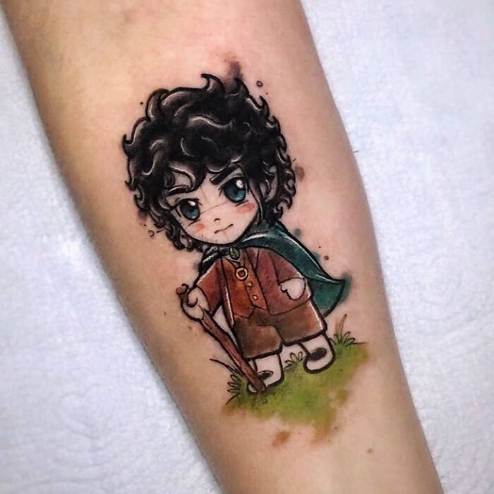 Frodo with big blue eyes holding a stick tattoo 