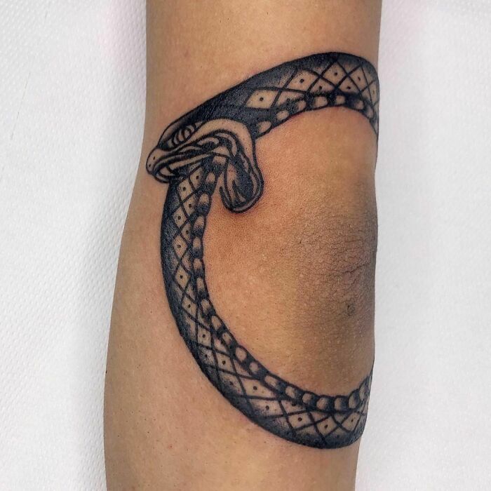 Snake tattoo around the elbow