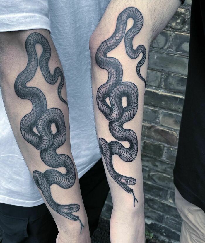 black mamba matching snake forearm tattoo
