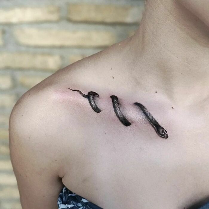realistic snake collarbone tattoo