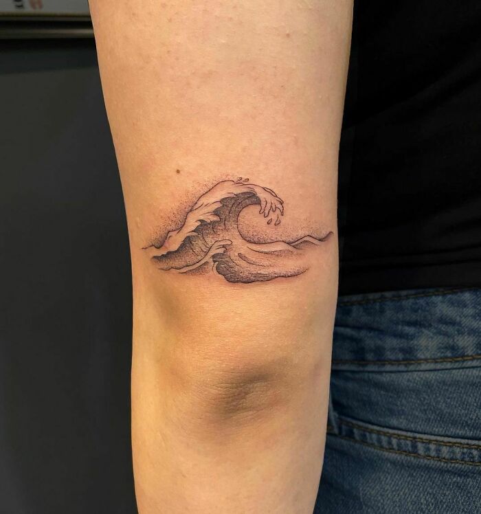Waves tattoo on the elbow