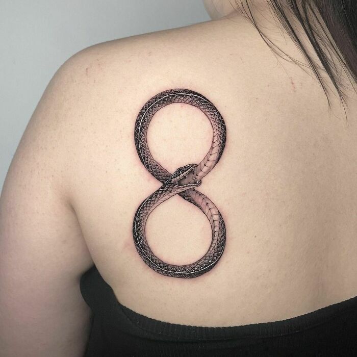 ouroboros snake infinity tattoo on back