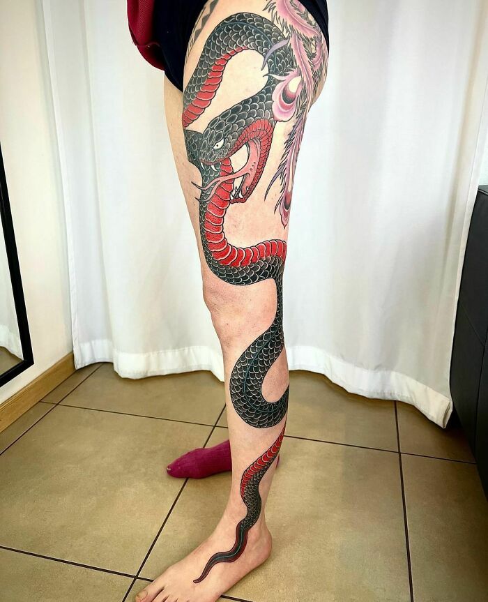 snake Wrapped around leg tattoo